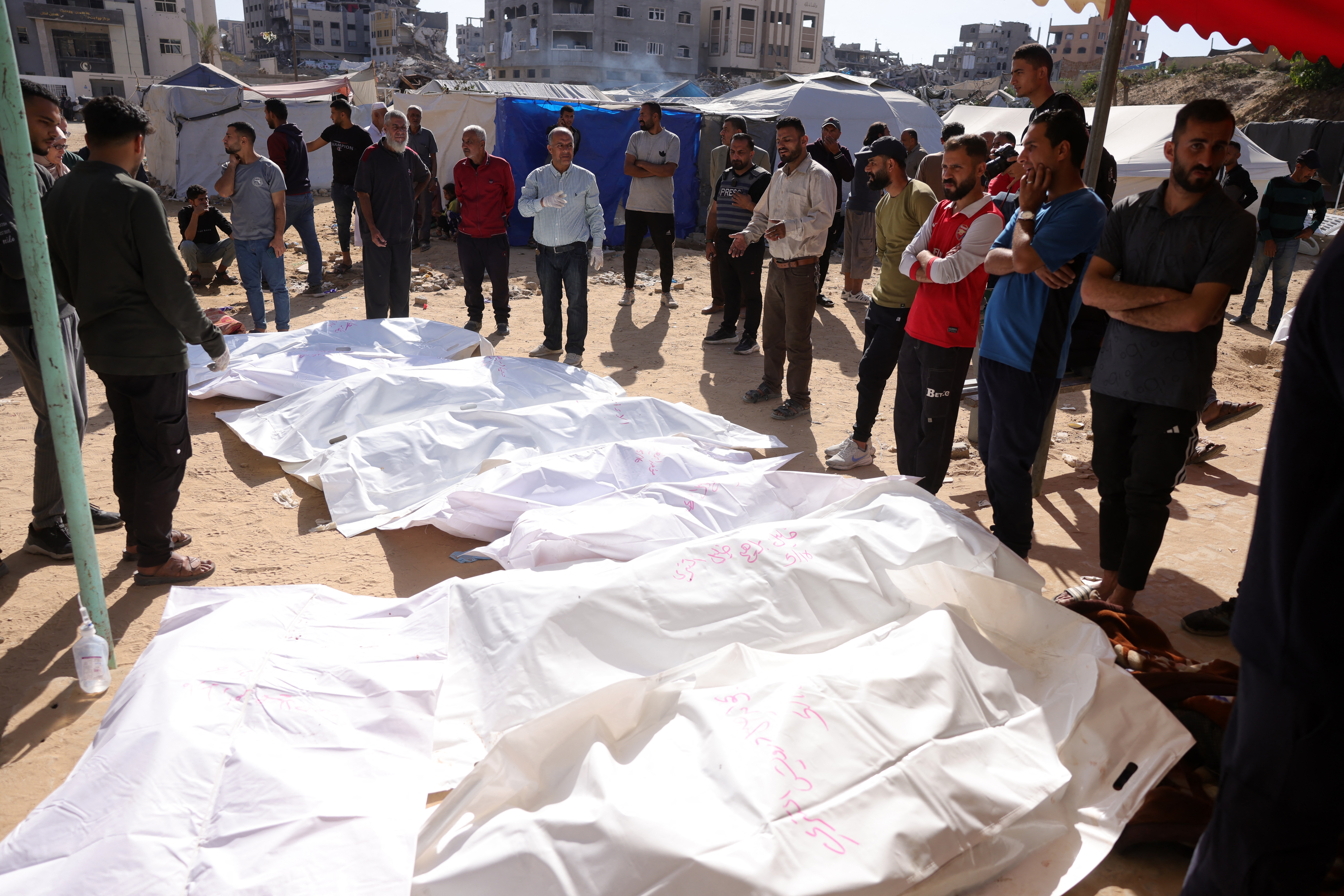 People surround the bodies of Palestinians killed in an Israeli strike in front of the Indonesian hospital in Beit Lahia in the northern Gaza Strip, on Friday.